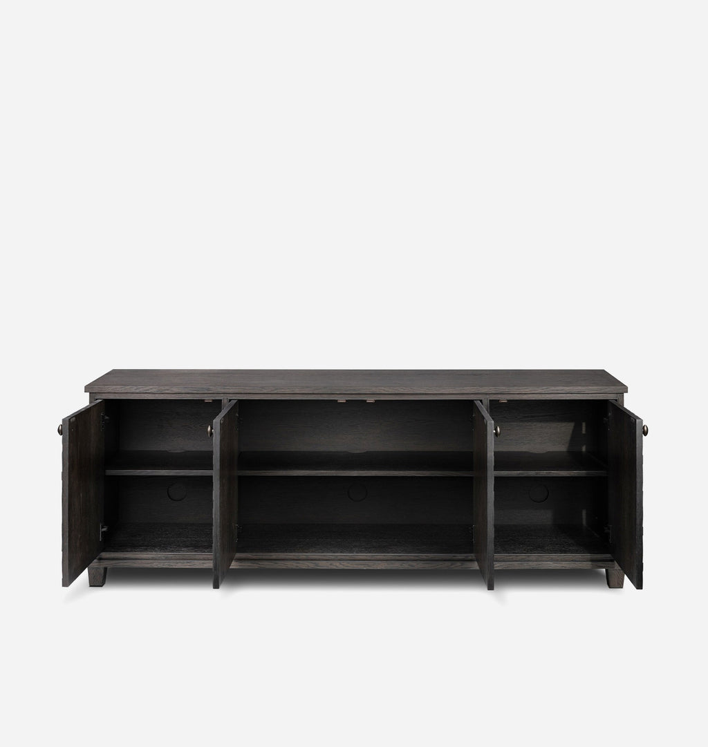 A dark gray wooden media console with two doors open, showing three interior shelves, photographed against a light gray background.
