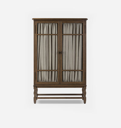 A tall wooden cabinet with two glass-paneled doors covered by beige curtains, shown against a plain light gray background.