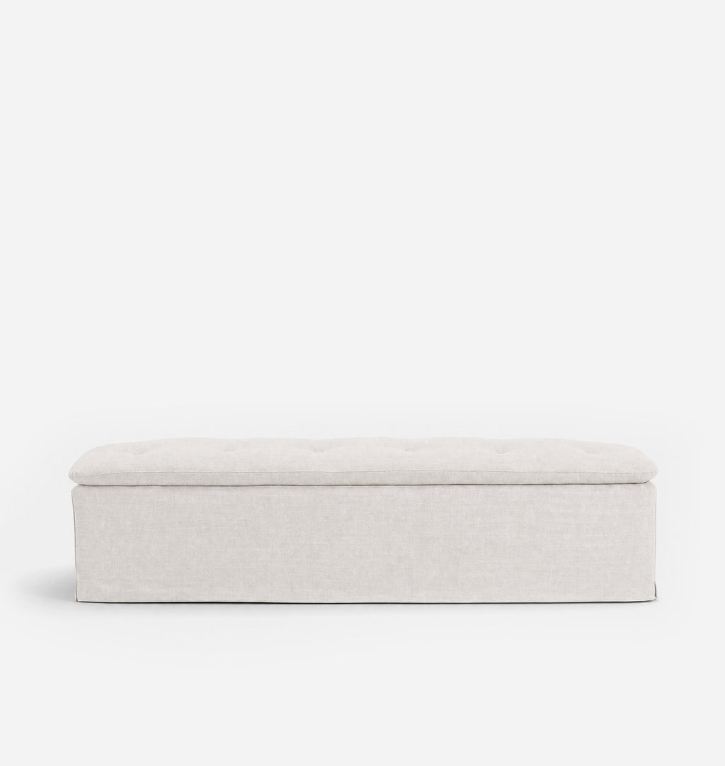 A rectangular upholstered bench with a tufted top cushion, shown from the front against a plain white background.