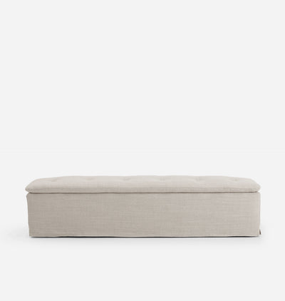 A rectangular upholstered bench with a tufted top cushion, shown from the front against a plain white background.