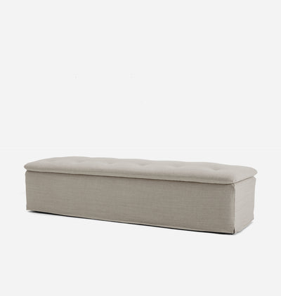 A rectangular upholstered bench with a tufted top cushion, shown from the front against a plain white background.