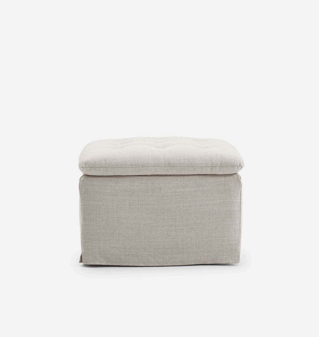 A square upholstered ottoman with a tufted cushioned top and a textured fabric body, shown against a plain white background.
