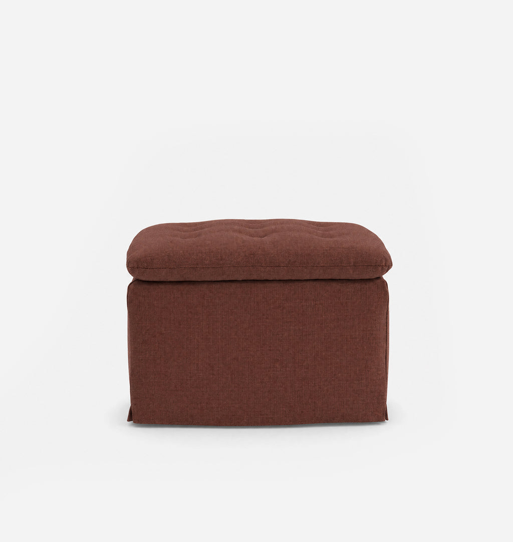 An upholstered ottoman with a tufted top, shown from the front against a plain white background.