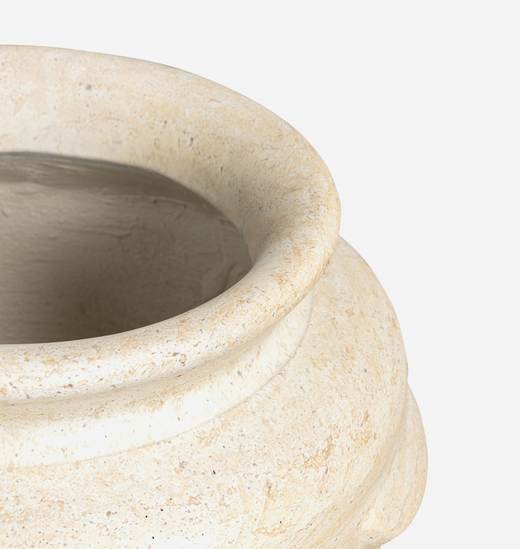 Close-up of a textured ceramic pot in a warm cream-beige color, showing the interior and the side of the vessel against a plain white background.