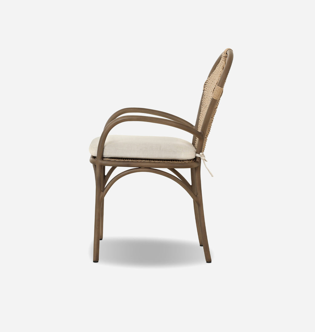 A bentwood dining chair with a curved armrest, a light beige woven cane backrest, and a cream-colored upholstered seat cushion, shown from a side profile against a light gray background.