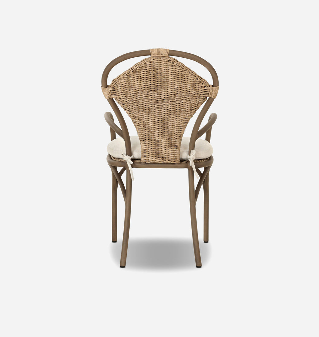 A classic French bistro dining chair with a curved brown wood frame, a natural woven rattan backrest, and cream-colored seat cushions tied with white strings, shown against a plain light gray background.