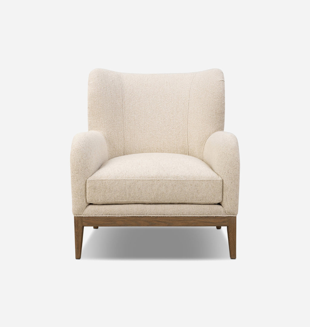 A modern wingback armchair with textured cream-beige bouclé upholstery and a medium brown wooden base, shown against a plain white background.