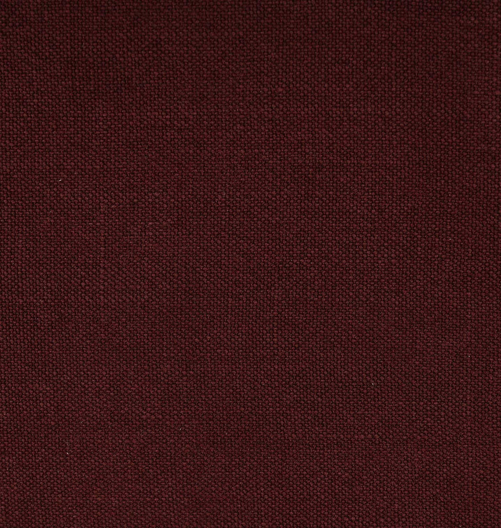 A close-up of a dark burgundy fabric texture with a fine woven pattern.