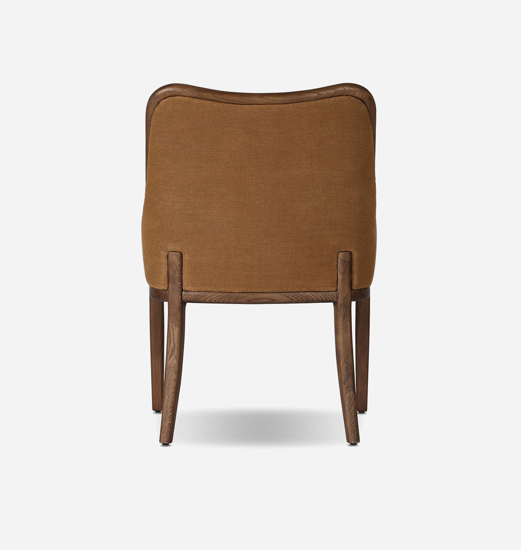 A modern dining chair shown from the back, featuring a warm brown textured fabric upholstered backrest and dark brown wooden legs and trim, set against a plain light gray background.