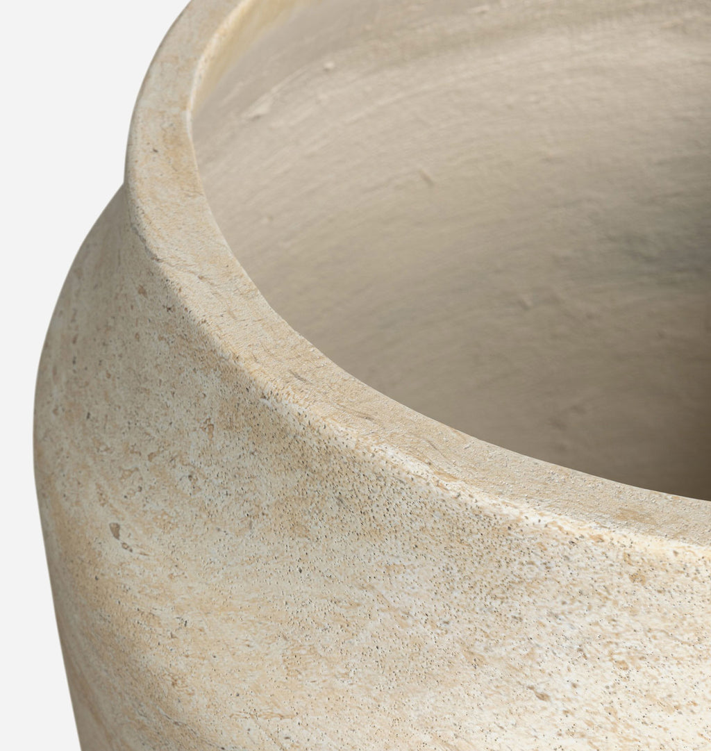 Close-up of a textured ceramic planter pot showing the beige stoneware exterior and smooth interior surface against a light gray background.