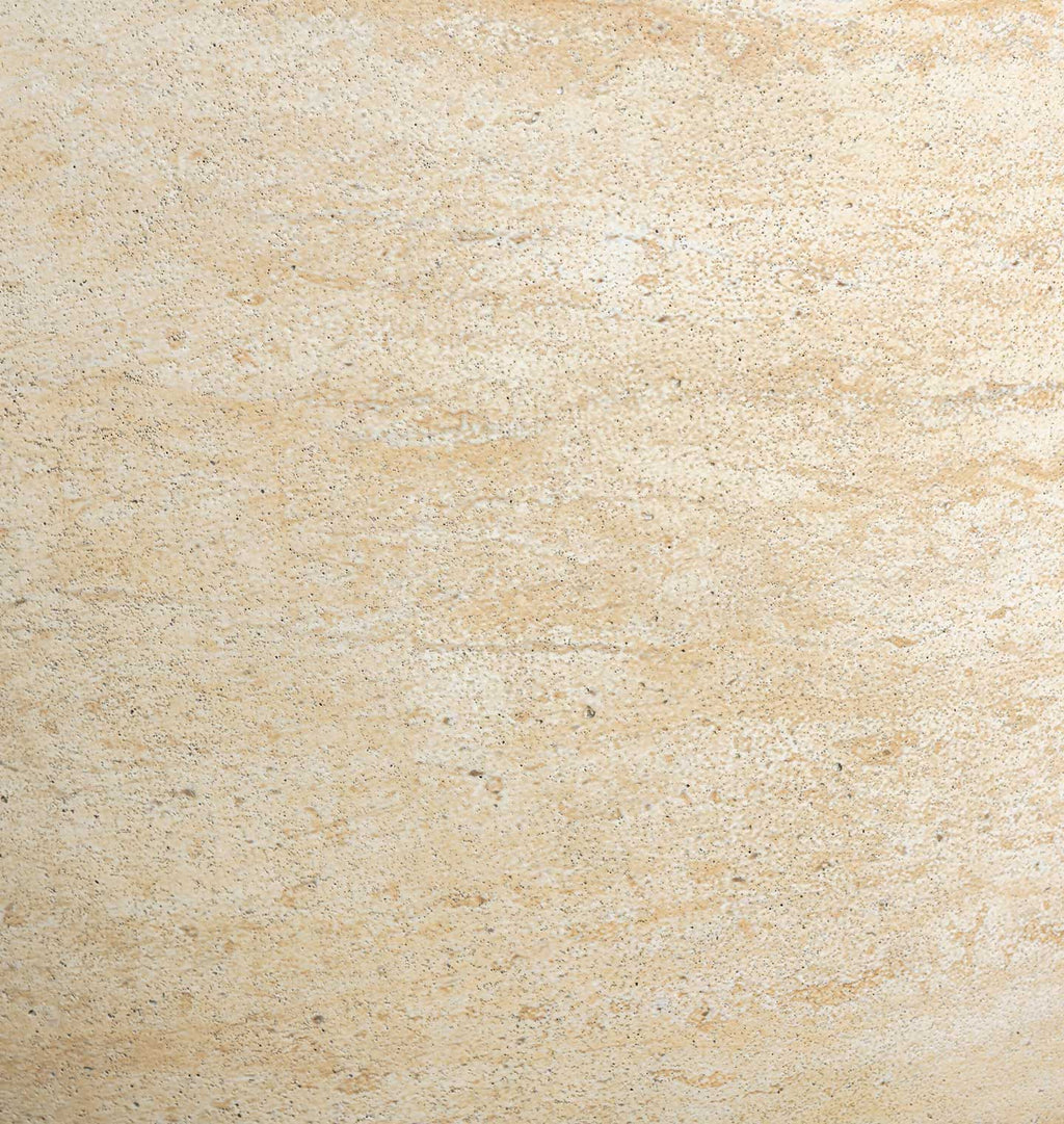 A close-up texture shot of a light beige stone or concrete surface with subtle natural variation and speckling.