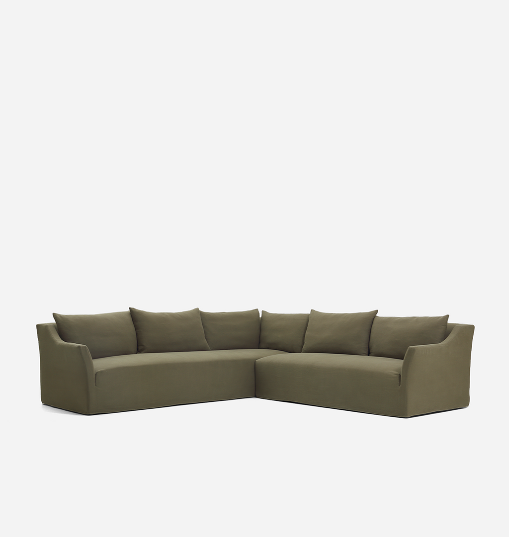 An olive green velvet sectional sofa with matching back cushions, shown from a front three-quarter angle against a plain white background.