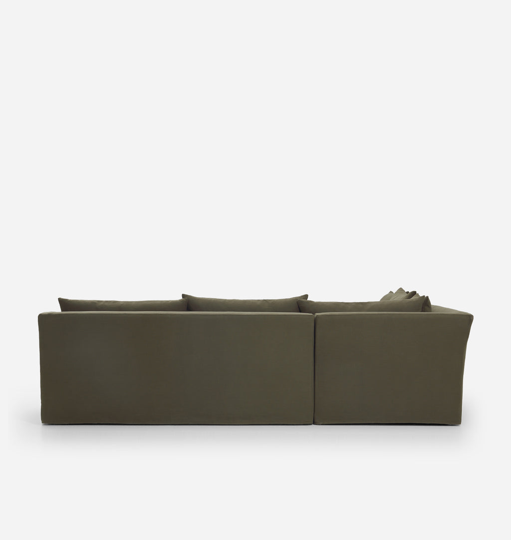 An olive green velvet sectional sofa shown from a low rear angle against a clean white background.