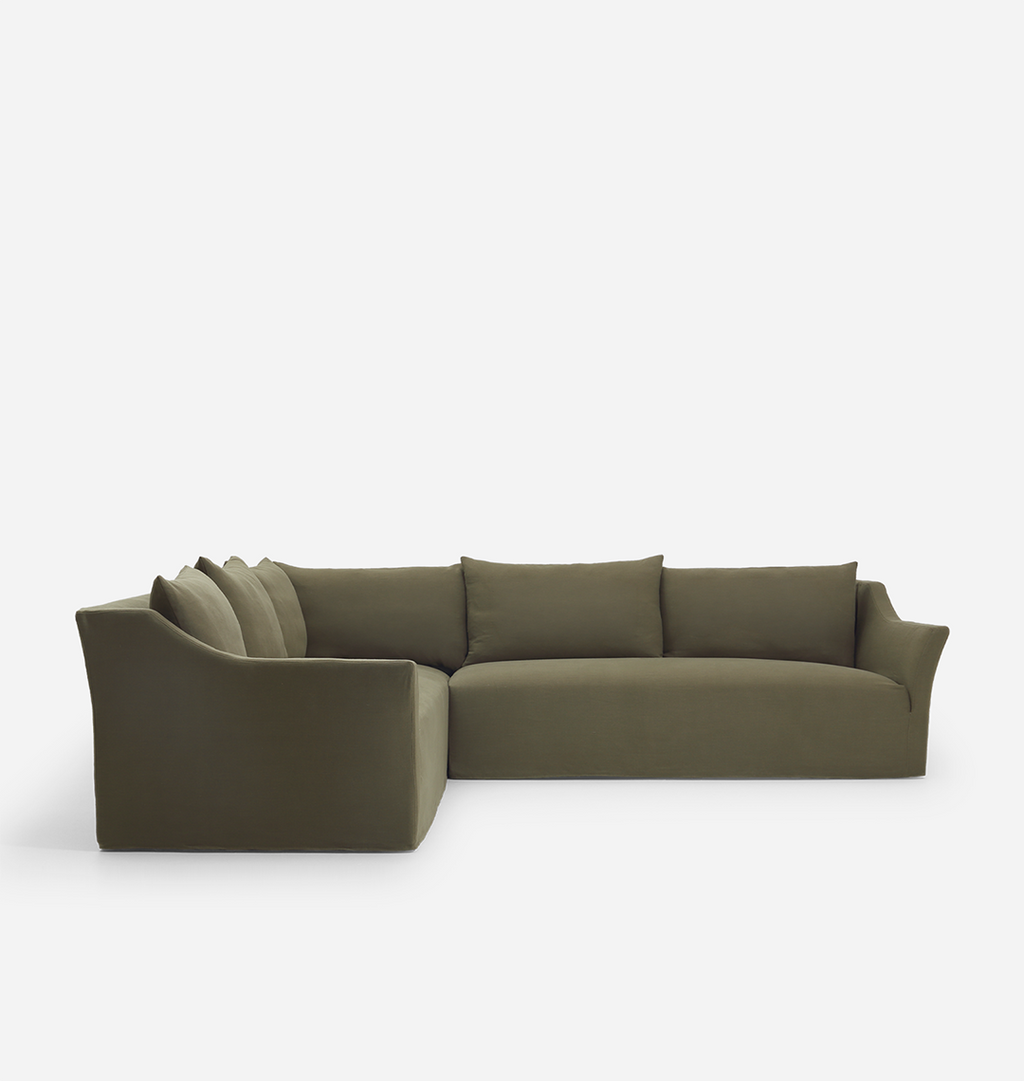 An olive green velvet sectional sofa with a left-facing corner and multiple matching back cushions, shown on a clean light gray studio background.