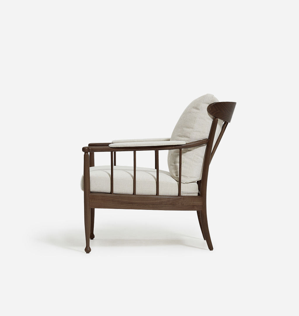 Wooden armchair with white cushions on a white background