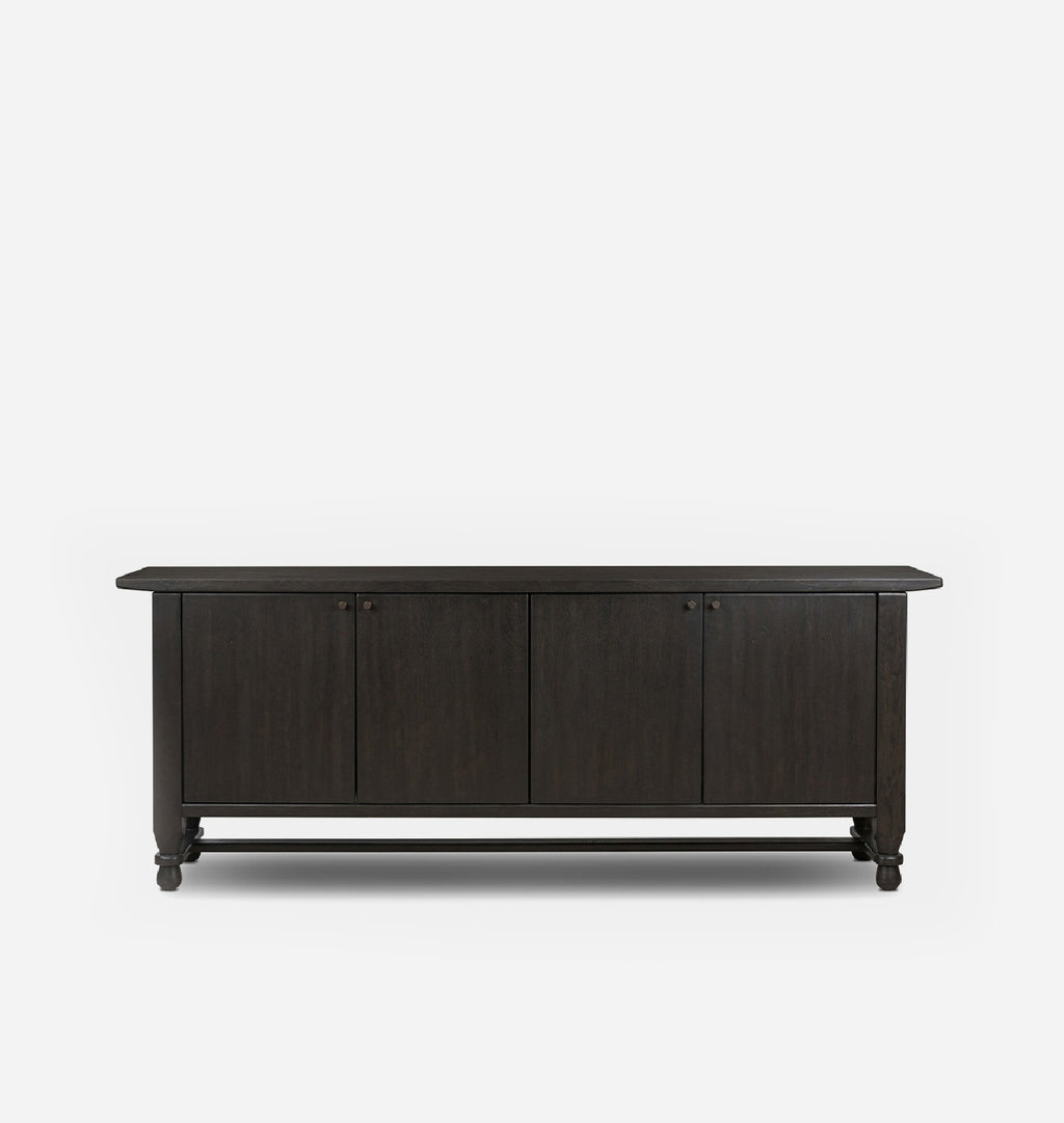 A dark brown wooden sideboard or credenza with four paneled doors and small round knobs, shown against a plain light gray background.