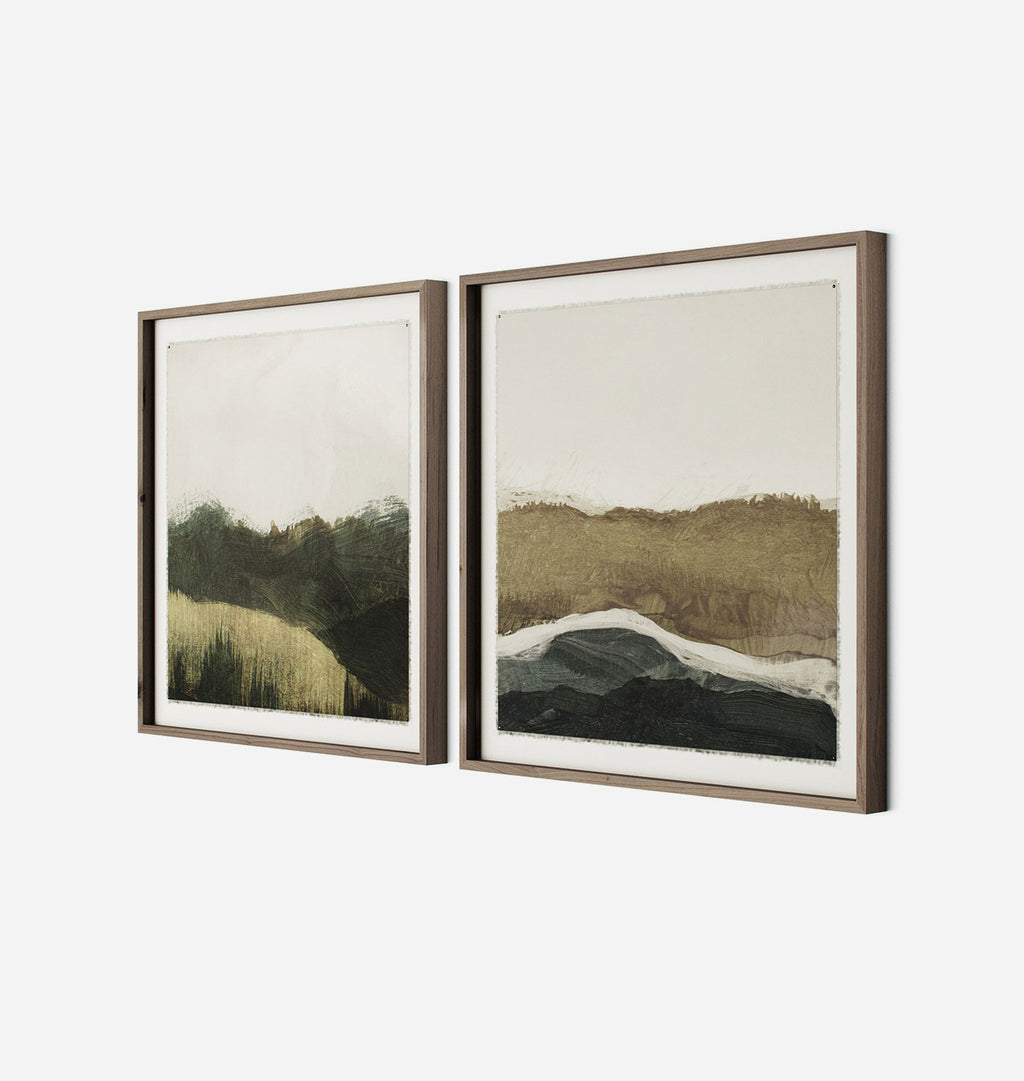Two framed abstract landscape art prints with dark brown frames, displayed side-by-side on a clean white wall.