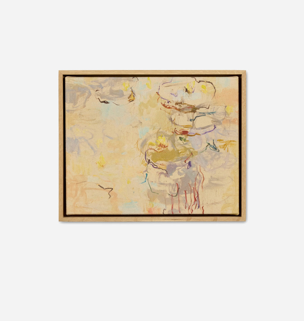 An abstract framed painting featuring a soft, impressionistic composition in warm beige, cream, and gold tones with subtle hints of yellow, blue, and red. The artwork is housed in a light natural wood frame and is centered against a clean, solid white background.
