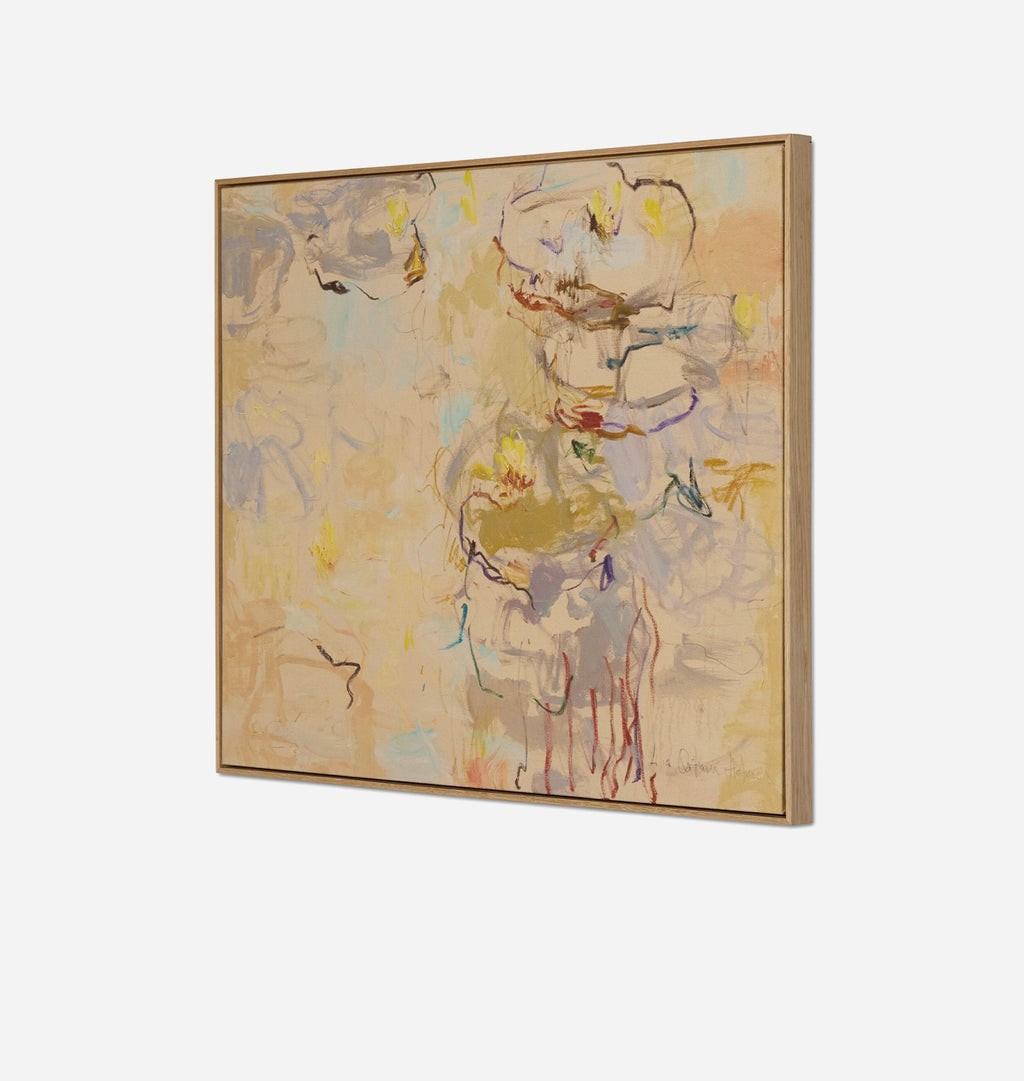 A square framed abstract painting featuring soft, impressionistic brushstrokes in beige, cream, muted gold, and hints of blue, pink, and red, displayed at an angle against a clean white background.