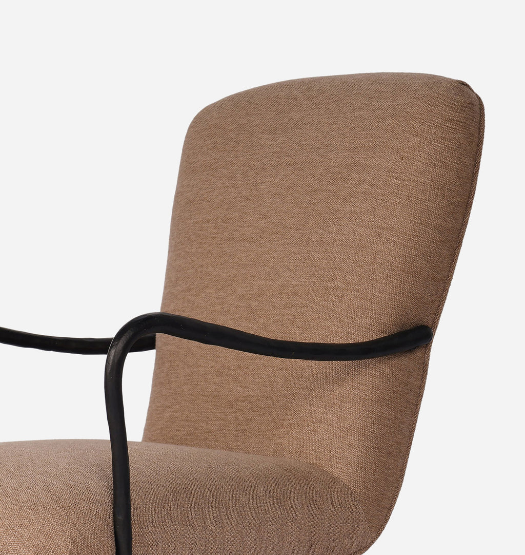 Close-up of a modern upholstered chair with a textured taupe-brown fabric seat and back, featuring a curved black metal armrest.
