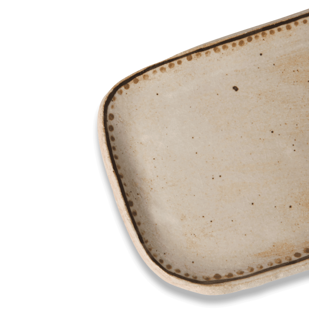 Open view of a ceramic butter plate decorated with a gold dotted accent line on a white background