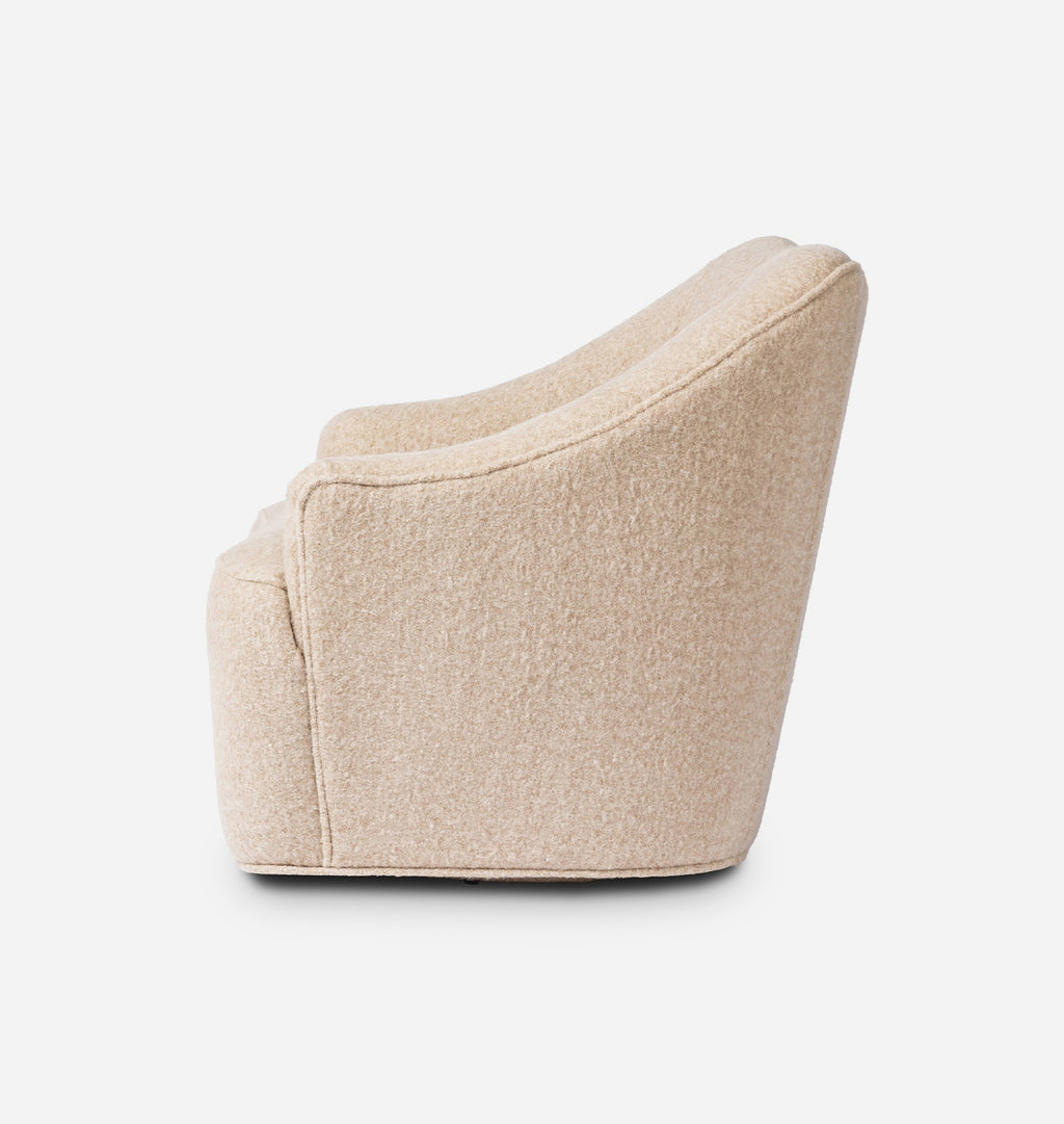 A modern low-profile accent chair upholstered in a textured beige bouclé fabric, shown from a side angle against a clean white background.