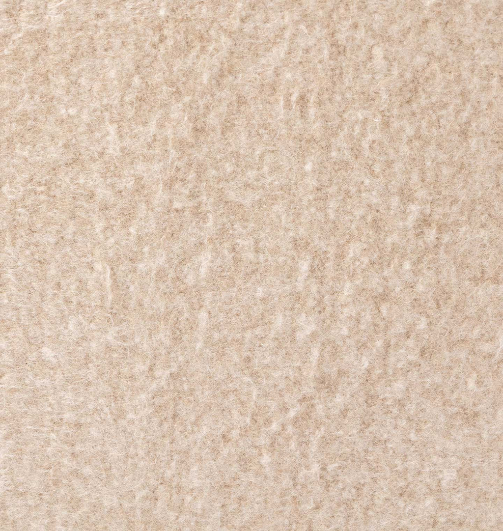A close-up texture shot of a beige, looped pile carpet or fabric swatch.