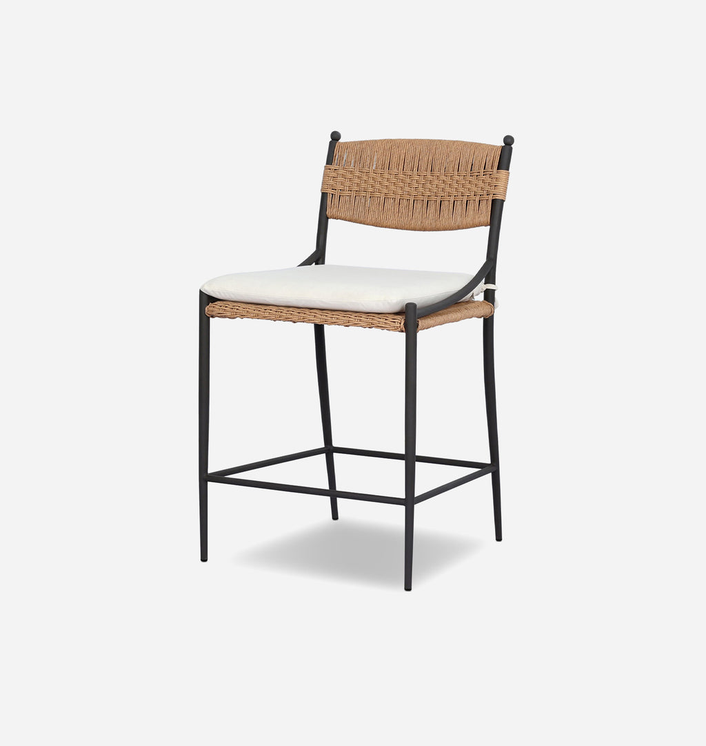 A modern counter stool with a black metal frame, a woven natural backrest and seat, and a white upholstered cushion, shown on a light gray background.