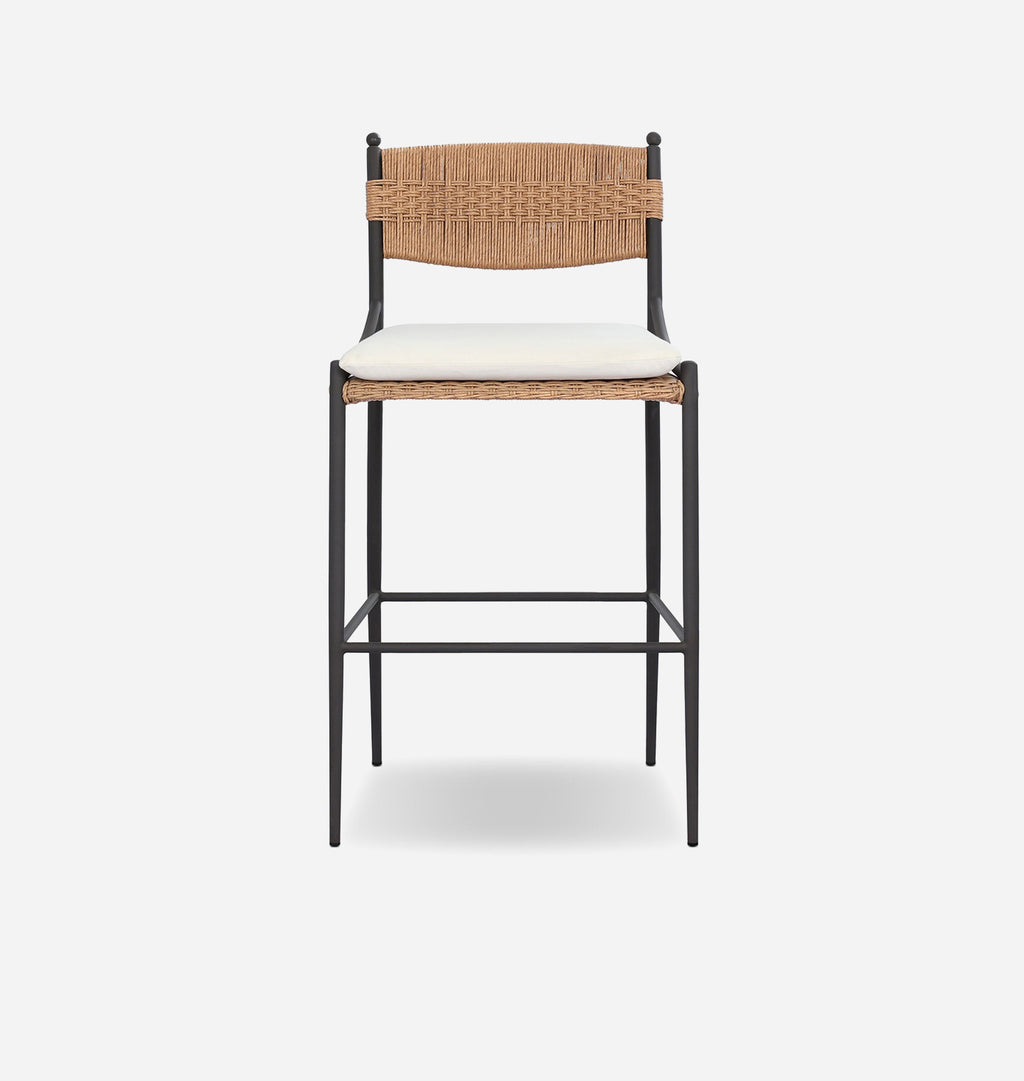 A modern bar stool with a black metal frame, a woven natural backrest, and a cream-colored seat cushion, shown against a light gray background.