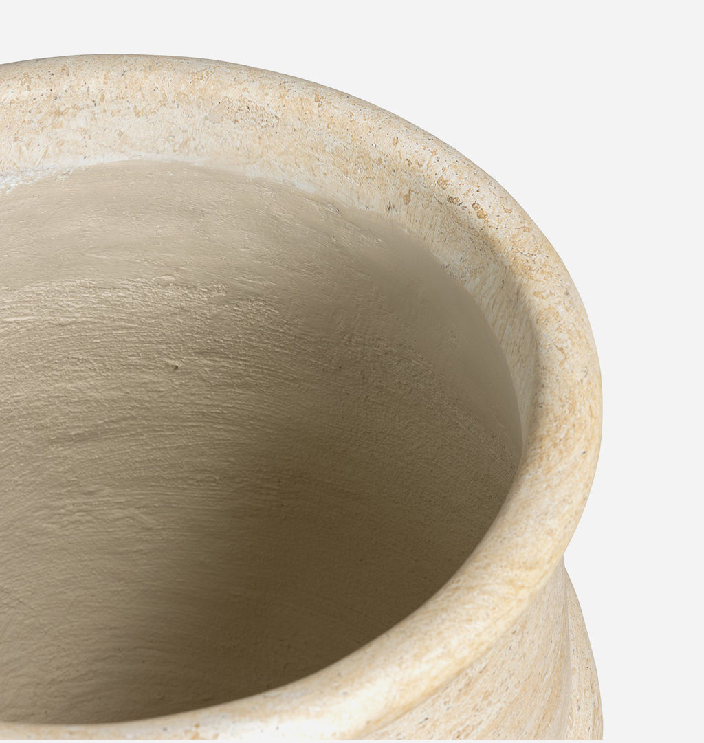 Close-up detail of a ceramic planter or vase with a textured, speckled beige and cream glaze, showing the interior surface and rim against a plain white background.