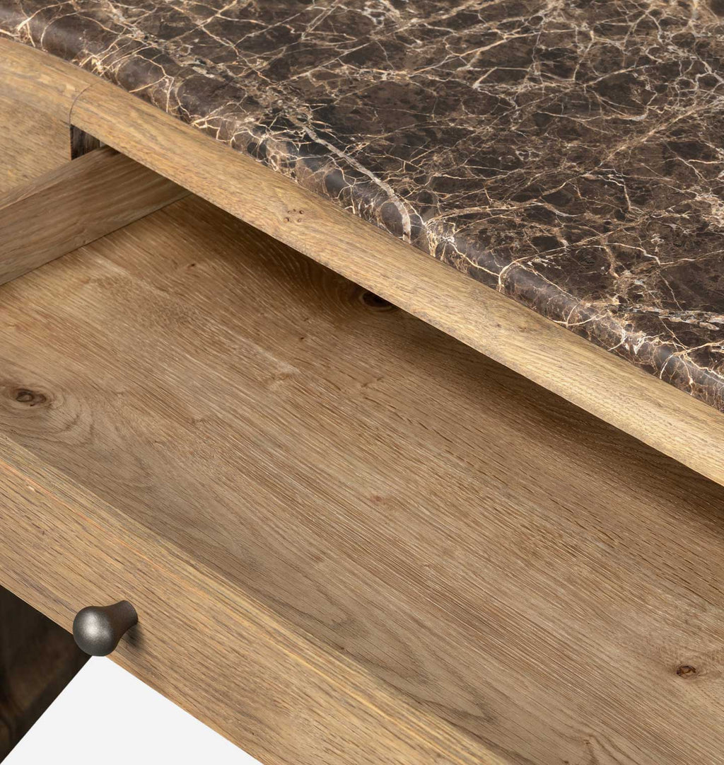 Close-up of a wooden drawer with a dark brown marble top and a round metal knob, showing the wood grain and texture.