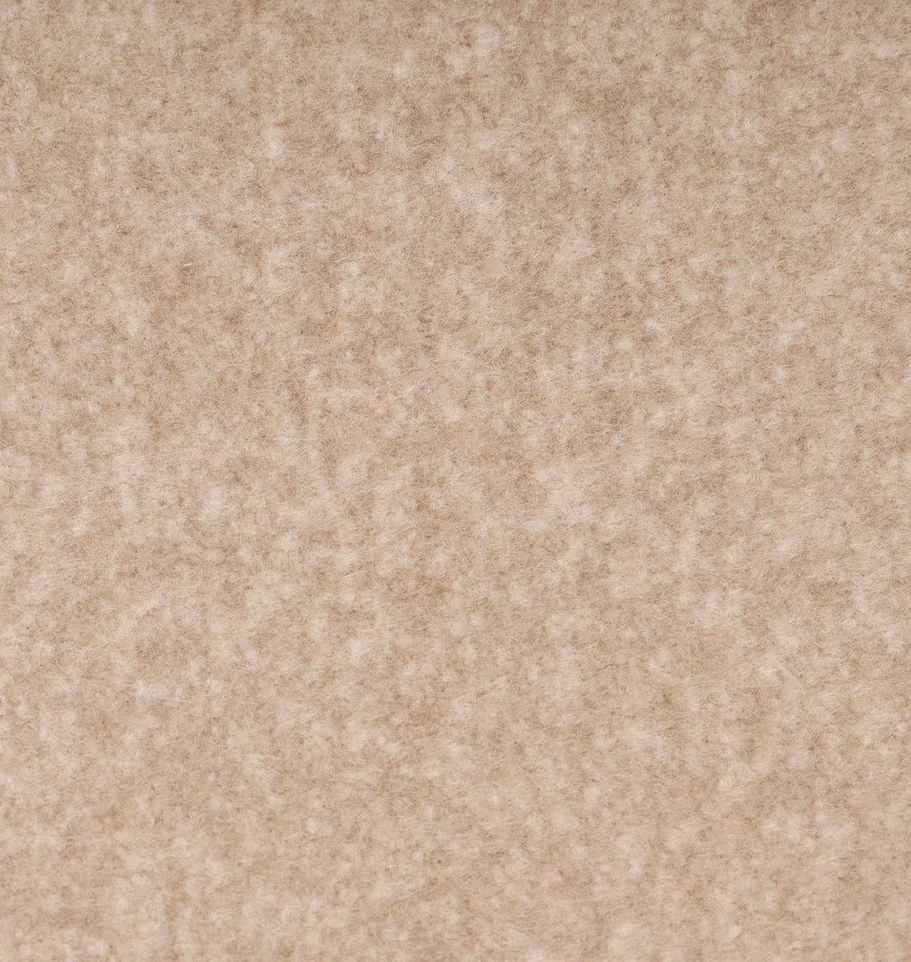 A close-up texture shot of a beige, mottled fabric or carpet material.