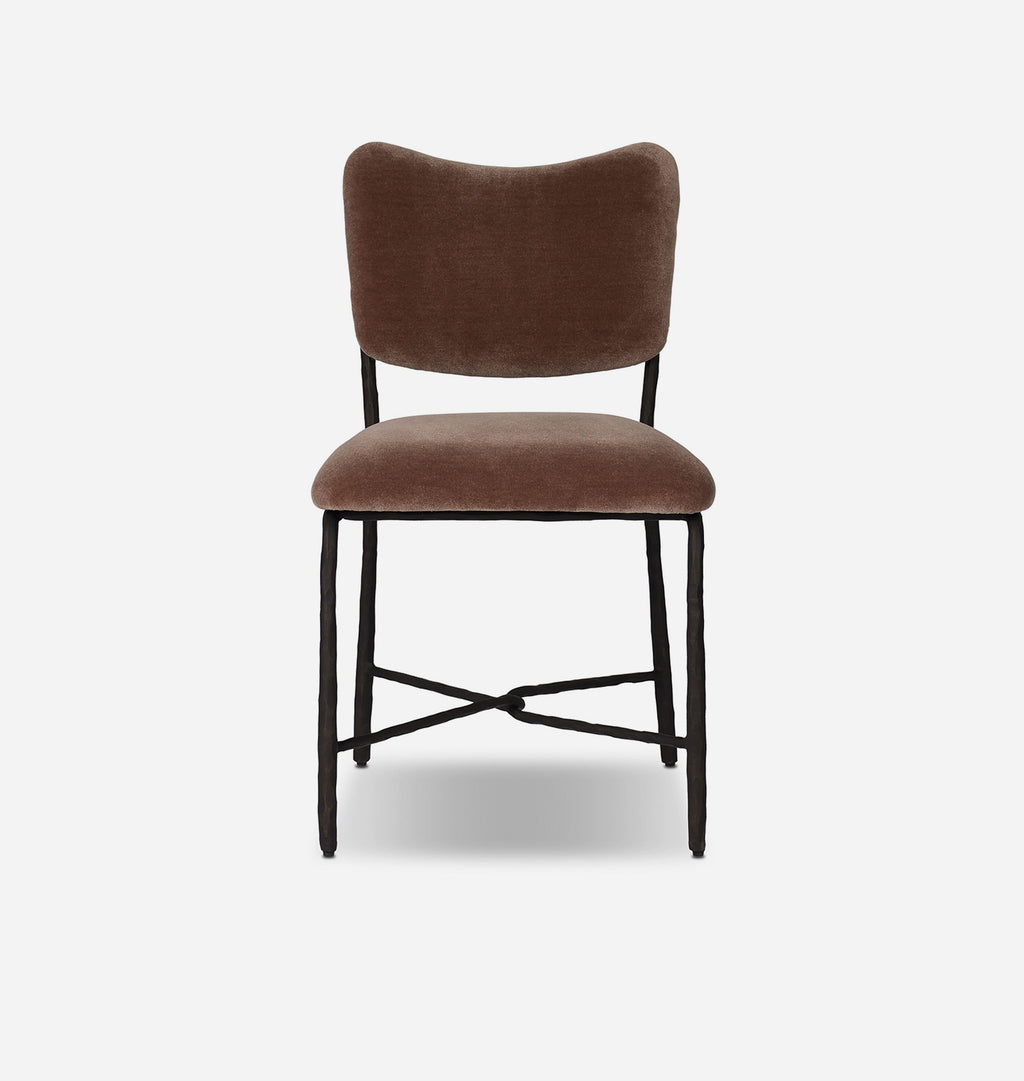A modern dining chair with a brown velvet upholstered seat and curved backrest, supported by a black metal frame with crossed legs, shown against a light gray background.
