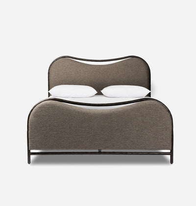 A modern low-profile bed with a curved upholstered headboard and footboard in taupe fabric, supported by a dark metal frame, shown with two white pillows on a light gray background.