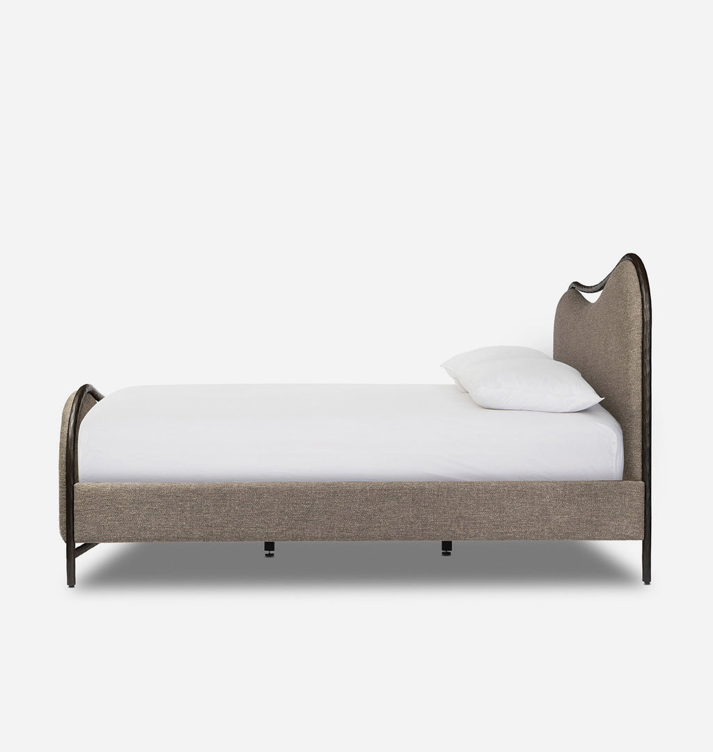 A modern single bed with a curved upholstered headboard and footboard in taupe fabric, shown with a white mattress and pillow against a plain white background.