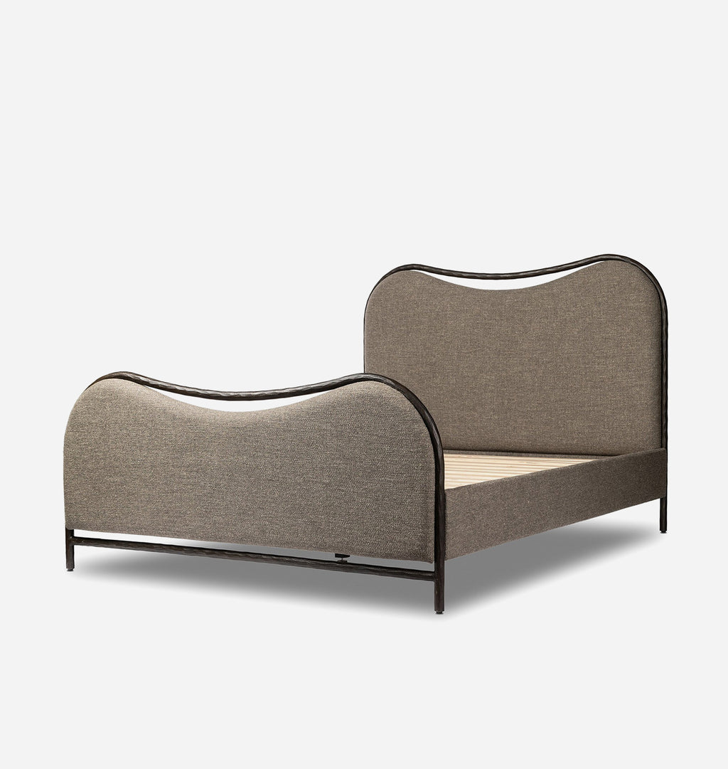 An upholstered bed frame with curved headboard and footboard in taupe fabric, outlined with a black metal frame, shown on a light gray background.