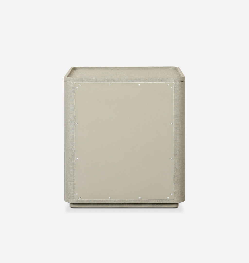 A modern, minimalist side table or cabinet with a square shape, upholstered in a light beige textured fabric, shown from the front on a clean white background.