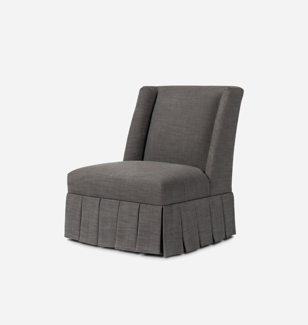 A gray upholstered accent chair with a high wingback backrest and a pleated skirt base, shown against a plain light gray background.