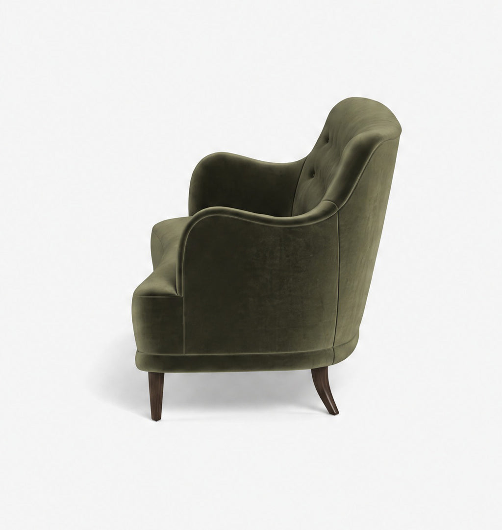 An olive green velvet armchair with dark brown wooden legs, shown from a three-quarters angle against a plain white background.