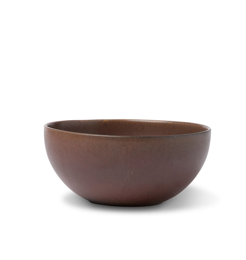 A ceramic pasta bowl finished in a reddish brown glaze shown on a white background