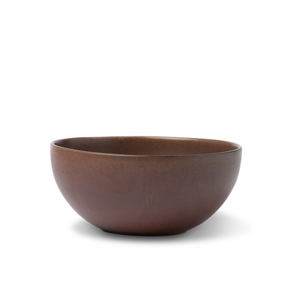 A ceramic pasta bowl finished in a reddish brown glaze shown on a white background