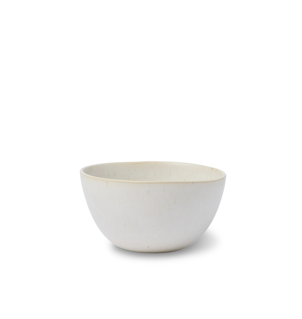 A ceramic cereal bowl finished in an off white glaze shown on a white background