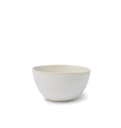 A ceramic cereal bowl finished in an off white glaze shown on a white background
