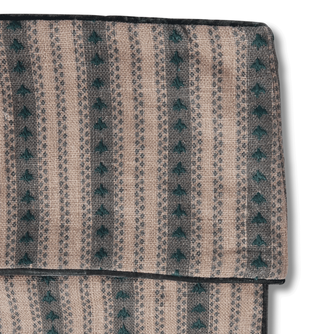 An embroidered striped stocking in a forest green color with matching velvet piping shown on a white background 