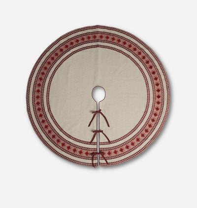 A round beige linen fabric tree skirt with a red embroidered border and a central hole for hanging, shown against a plain light gray background.