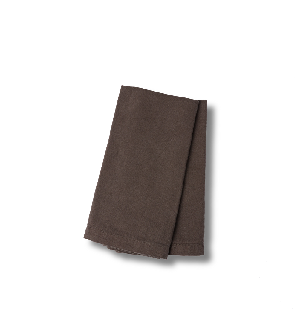 A folded set of two brown napkins with a stitched hem, displayed on a clean white background.