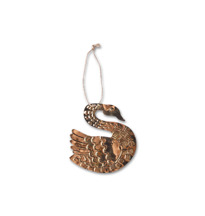 A decorative gold-toned Christmas ornament embossed with motifs in the shape of a swan set against a white background