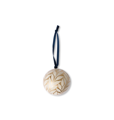 A hand-painted paper mache ornament with golden vine and floral motifs with a velvet ribbon tie set on a white background