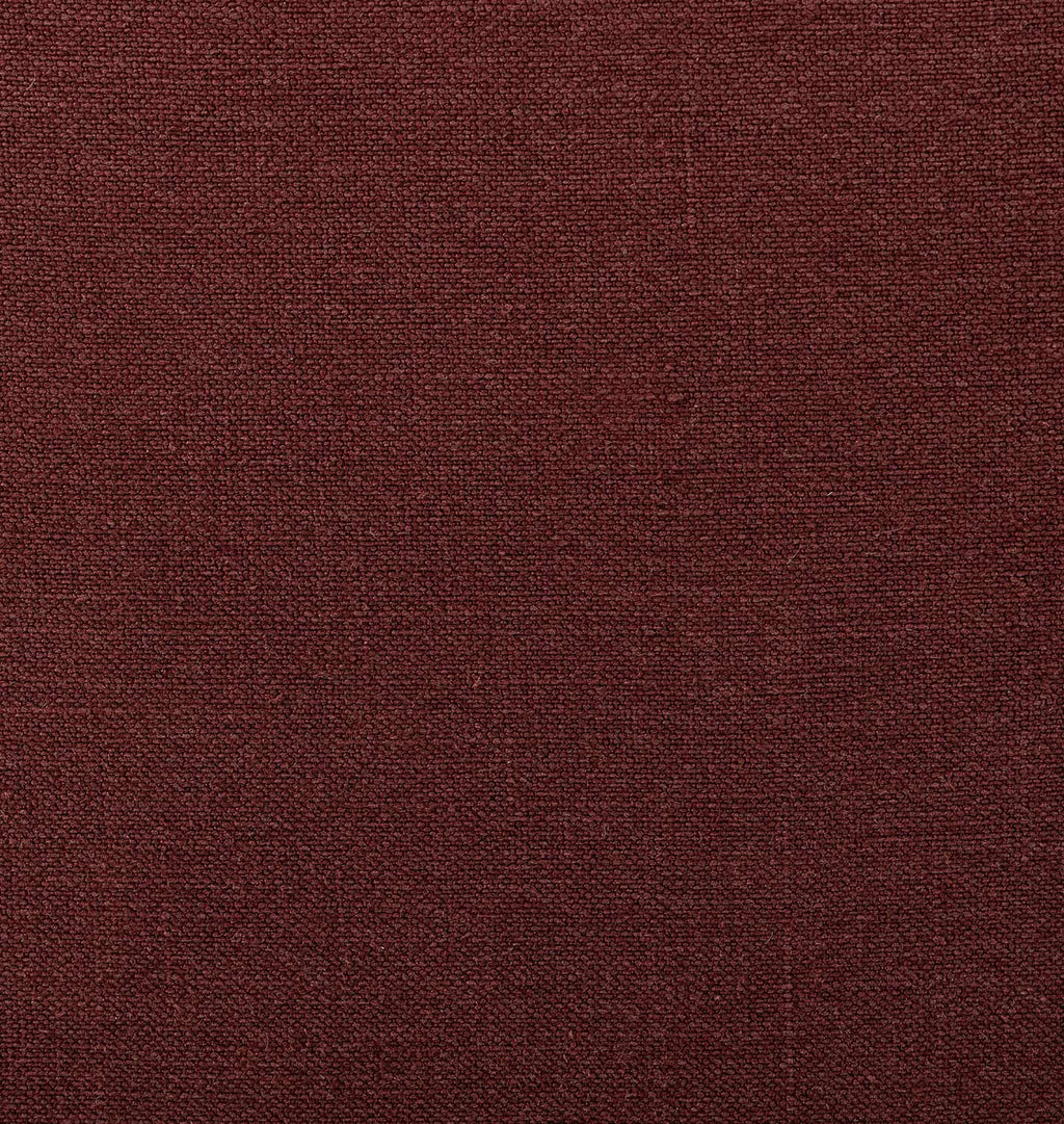 A close-up of a textured fabric in a deep burgundy or maroon color, filling the entire frame.