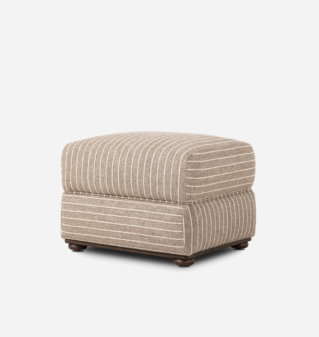 A square upholstered ottoman with a beige and white striped fabric, dark wood feet, and a clean white background.